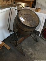 Front view of the churn showing wooden barrel and metal support frame