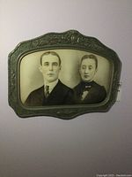 Full view of antique convex photo frame showing the portrait and entire frame design