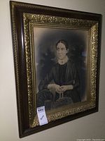 Full view of the large ornate framed black and white portrait of a woman