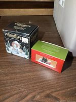 Two small boxed village figurine sets: Victorian Village Collectibles 1987 Edition and Simple Traditions Illuminations