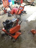 Side angled view showing front tines, engine mounting and overall condition