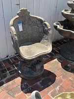 Full view of the cast concrete chair showing sculptured details and shape.