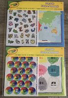 Photo showing 2 Crayola Fun Felt sets sealed in packaging, one with a geography world map and animals, one with colorful circles and animal faces.