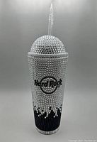 Front view of the Hard Rock Bling tumbler covered in clear rhinestones with black drips and black Hard Rock logo.