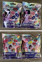 Two unopened packages of My Little Pony Surprise Rings in original colorful packaging showing various My Little Pony characters and images of the rings inside.