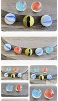 Five vintage handmade glass marbles, various multicolor swirl and solid patterns shown with ruler for size reference.