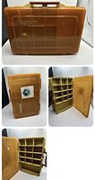 Front view of yellow Plano Magnum tackle box showing translucent lid with embossed brand names and brown handle.