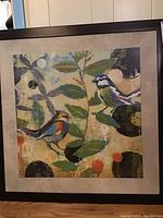 Full view of the framed art print showing two birds on branches with an abstract style and neutral background, mounted and framed.
