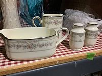 Gravy boat, creamer and salt & pepper shakers with floral and silver rim pattern