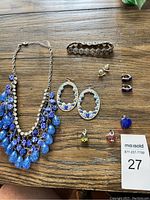 Full overview of all jewelry items on wooden surface