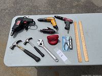 Overview of larger hand tools and rulers on table.