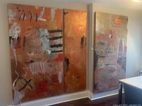 Two large side-by-side copper-orange abstract panels on a wall