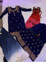 Photo showing entire lot of four items: navy blue embroidered dress, matching skirt, white and blue dupatta, and pink-black sleeveless dress