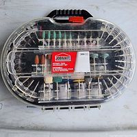 Full top view of the complete 300-piece Jobmate rotary tool accessory set in translucent plastic case with handle and orange clasp showing various accessories from above.