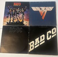 Front covers of four vinyl record albums including Kiss Destroyer, Van Halen, AC/DC Back in Black, and Bad Company