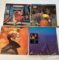 Front covers of Cyndi Lauper's 'She's So Unusual', Bee Gees 'First', David Bowie's 'Low', and Wham! albums