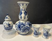 Photo of all 6 Delft items: one large vase, pair of two small vases, and a ginger jar with lid