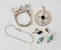 Photo showing the lot consisting of dragonfly brooch, floral ring, circular pendant, necklace chain, and three pairs of earrings with various stones.