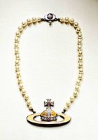 Full front view of necklace showing orb pendant, faux pearls, and clasp