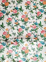 Full view of vintage floral patterned fabric with pink, orange, yellow, green, and blue flowers on white background.