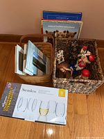 Overall view showing wicker basket, packed with figurines, picture frames and boxed stemless glass set