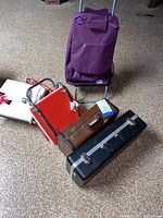 Overview of all items: trumpets in cases, stadium seats, seat cushion and trolley bag