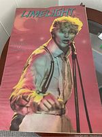 Color photo of Limelight magazine cover featuring David Bowie singing, wearing suspenders and light shirt.