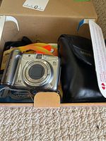 Canon PowerShot A720 IS camera and Minolta Freedom AF camera in box with case.