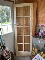 Full view of the white painted wooden door with 10 glass inserts showing overall condition and setting.
