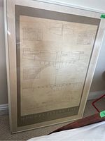 Full framed blueprint showing Hughes Flying Boat specifications, diagrams and measurements visible in a glass frame.