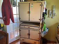 Front view of entire closed cabinet showing overall shape, finish, handles and hardware