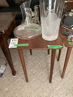 Full view of wooden side table with glass items on top showing general condition and size