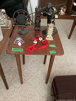Top-down view of the wooden table showing surface water marks and various decorative items placed on top.