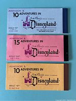 Three Disneyland ticket books showing front covers with admission details and age categories