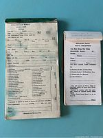 Photo of two vintage police traffic ticket books from Edwardsville, Kansas, showing front pages with printed checkboxes and handwritten notes.