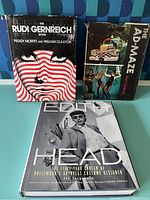 Three hardcover books standing/upright on surface, showing front covers and overall condition of dust jackets with visible wear and creases