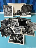 Overview of approximately 16 vintage black and white Denver photographs laid out, showing variety of cityscape and interior shots