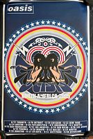 Full view of the Oasis poster with band name, circular graphic design featuring mirrored figures and lightning bolts, surrounded by stars.