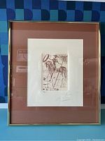 Full view of the framed etching against patterned background