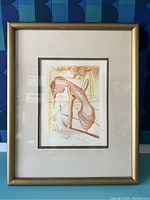 Full view of framed lithograph showing gilt metal frame and fabric mat surrounding artwork