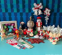 Wide view of all Christmas ornaments including boxed balls, figurines, nutcracker, bells, stars, and snowflakes