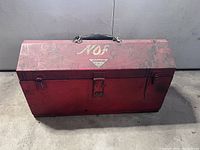 Closed red Snap-On toolbox showing wear and Snap-On logo on top with a metal handle.