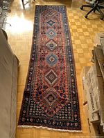 Full-length view of runner on parquet floor showing overall pattern and edge condition