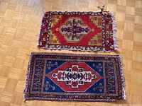 Top view of both Turkish carpets side by side on a wooden floor showing patterns and overall wear.
