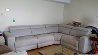Front view of entire four-piece sectional couch positioned in corner of room