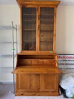 Front view of the full pine secretary cabinet showing top leaded glass doors, drop down desk and cupboard