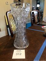 Full view of the tall clear cut glass vase showing overall shape and weight card.