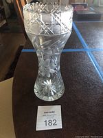 Front view of the crystal vase showing deep allover cut pattern with flower motif and sawtooth rim
