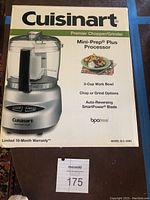 Photo of the front of the box with product image, brand name, and key features like Premier Chopper/Grinder, 3-Cup Work Bowl, Chop or Grind Options, and Auto-Reversing SmartPower Blade. Model DLC-2ABC.