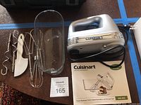 Full lot displayed including electric mixer with cord, dough hooks, beaters, whisk, spatula, mixing guard container, and instruction manual.